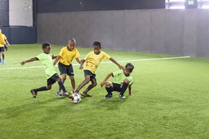 A group of boys playing football on a field