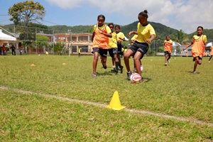 Teenager girls playing football