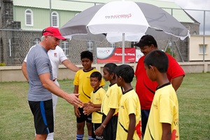Visit of David Ginola talking to the children