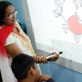 Teacher showing children how to draw