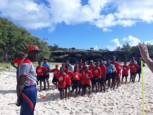 Children queuing in Rodrigues and preparing their beach soccer match